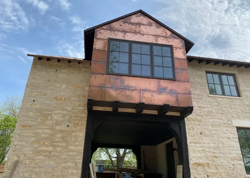 Copper metal panel facade on a stone building for Roof Repair in El Mirage